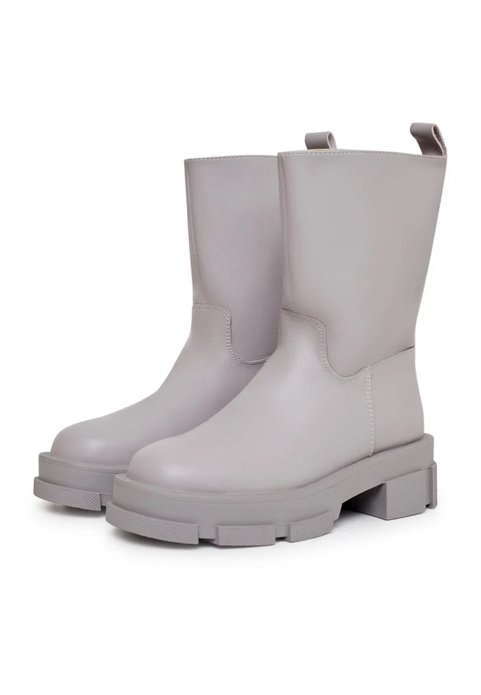 A stylish pair of women's fashion ankle boots in beige leather with a chunky sole.