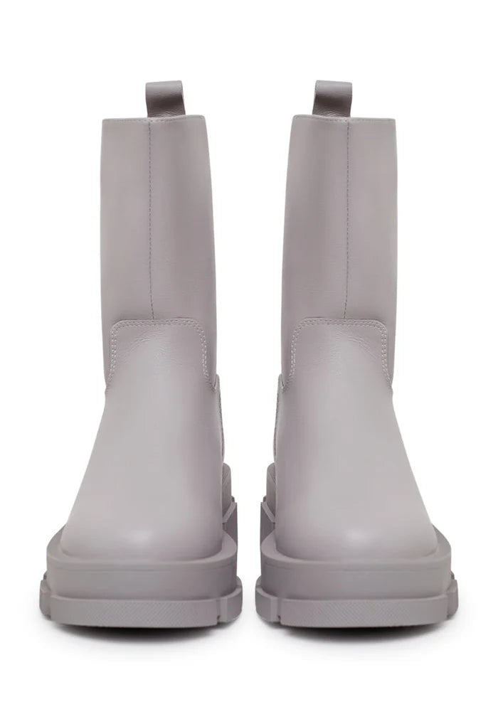 A stylish pair of women's fashion ankle boots in beige, featuring a chunky sole and made from leather.