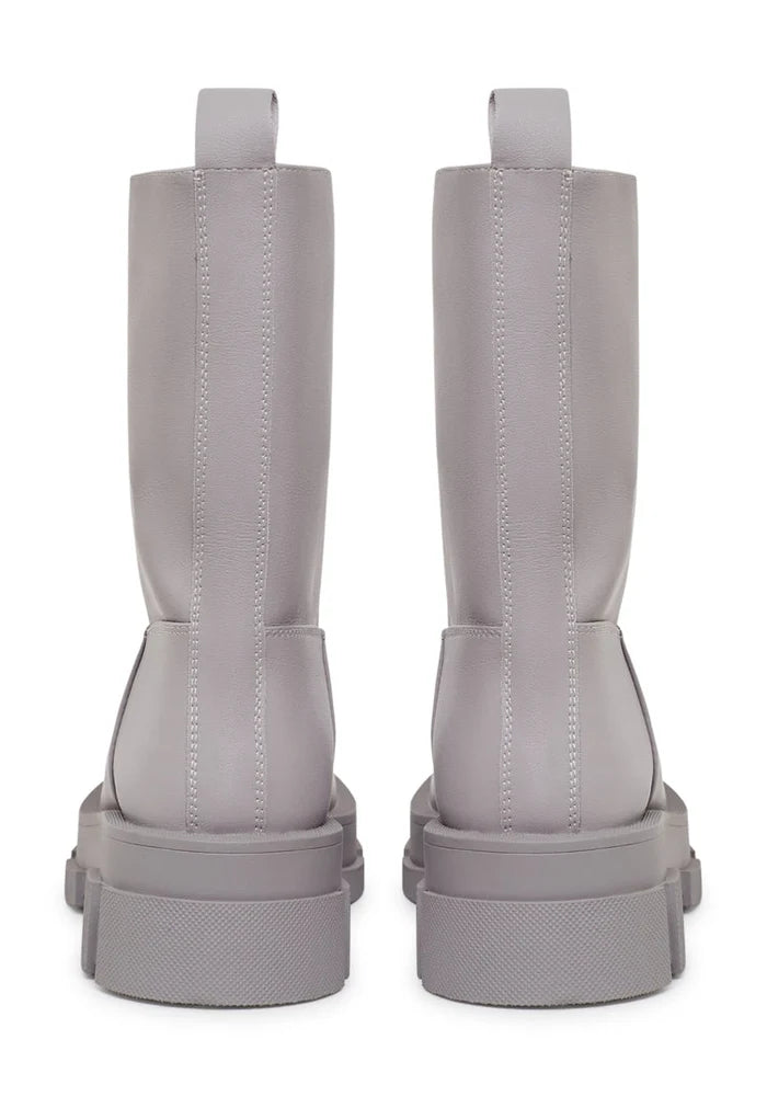 A stylish pair of women's chunky sole leather ankle boots in a trendy beige color, perfect for fashion-forward looks.