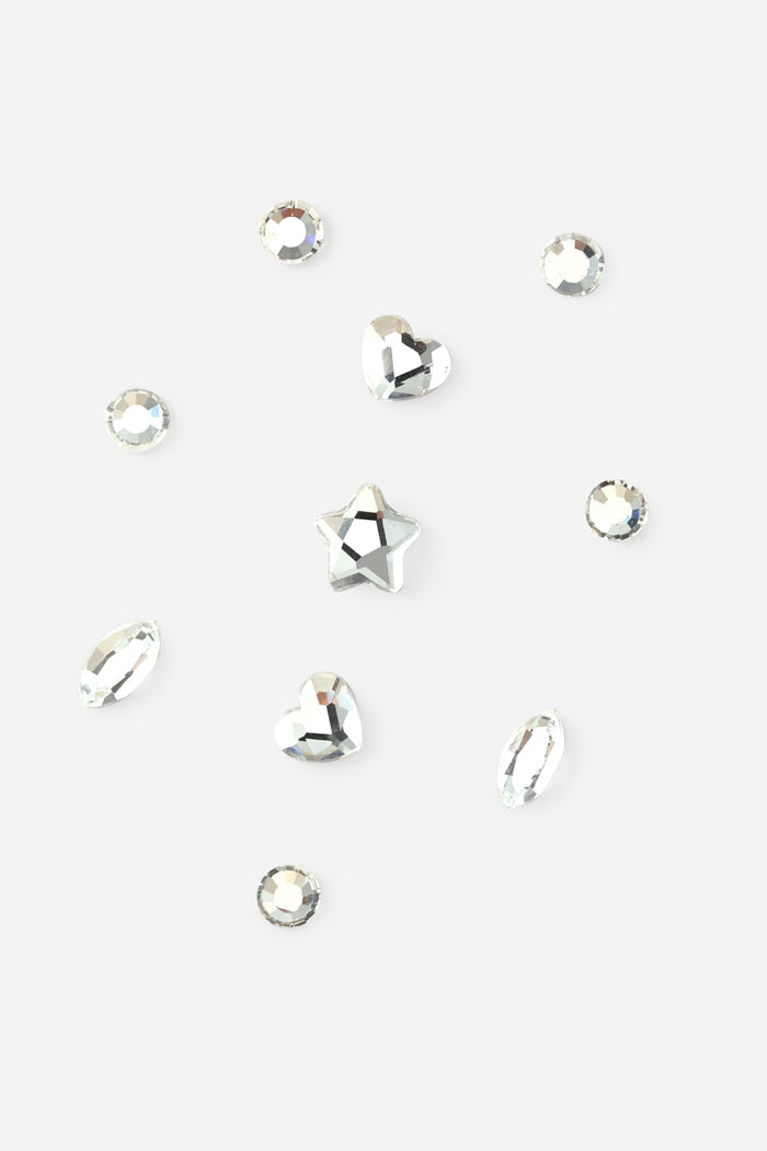 Clear crystal tooth gems in round, heart, star, and marquise shapes for a DIY tooth gem kit.
