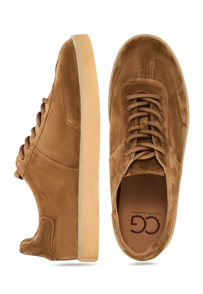 A pair of stylish brown suede sneakers, featuring a classic low-top design with a retro-inspired look.