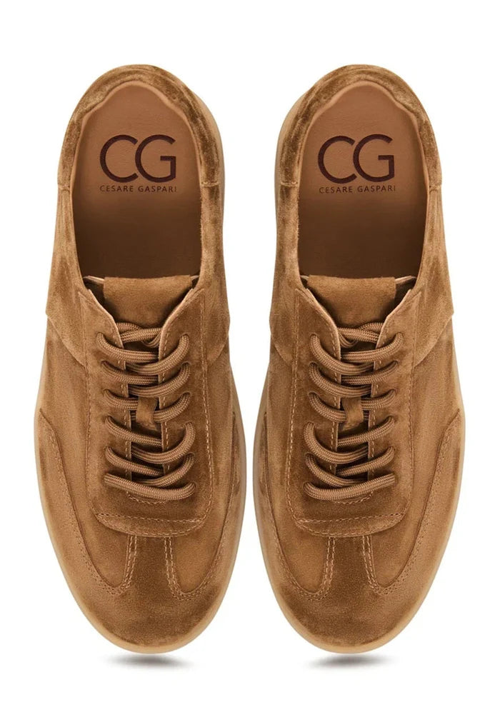 A pair of stylish brown suede sneakers, classic low-top design with a retro-inspired look.