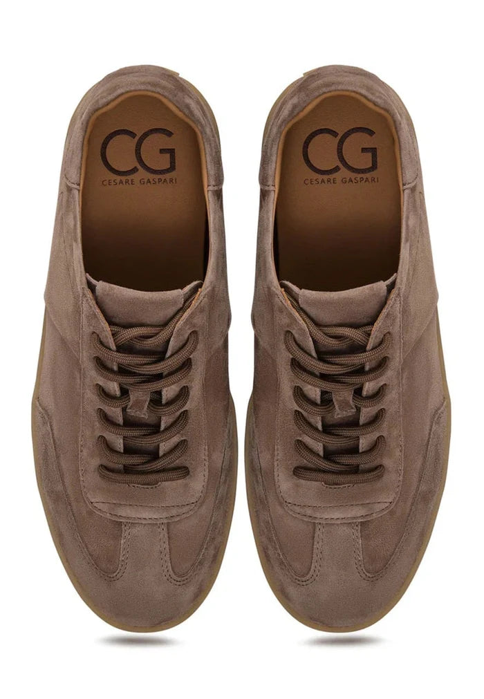 A pair of stylish low-top suede sneakers in classic beige color, perfect for footwear fashion enthusiasts.