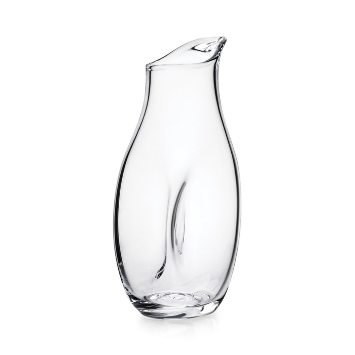 Clear glass carafe with curved body and angled pouring spout at top.