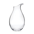 Clear glass carafe with curved teardrop shape and angled pouring spout.