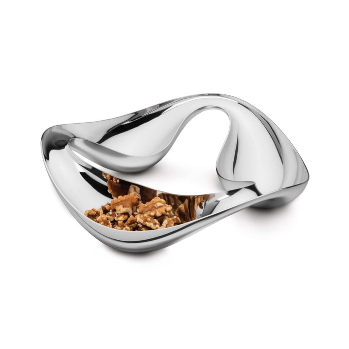 White and chrome triple snack bowl with curved sections containing nuts and snacks.
