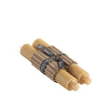 Two natural tapered column candles bundled together with a black label band.