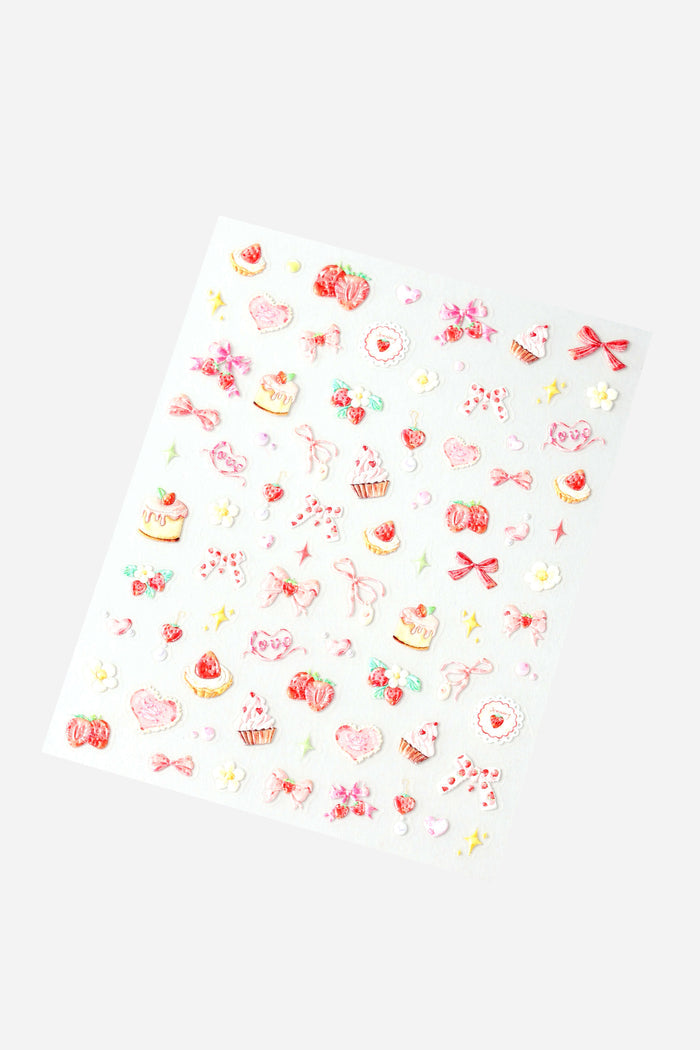Sheet of coquette cutie nail stickers featuring strawberries, hearts, cakes, and bows in pink and red.