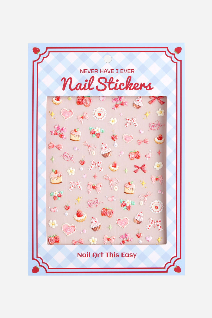 Sheet of Coquette Cutie nail stickers featuring pink bows, strawberries, cupcakes, and hearts.