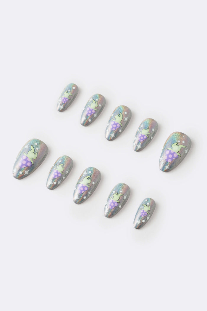 Cosmic Dance press-on nails: holographic silver with green alien on purple skirt, stars.
