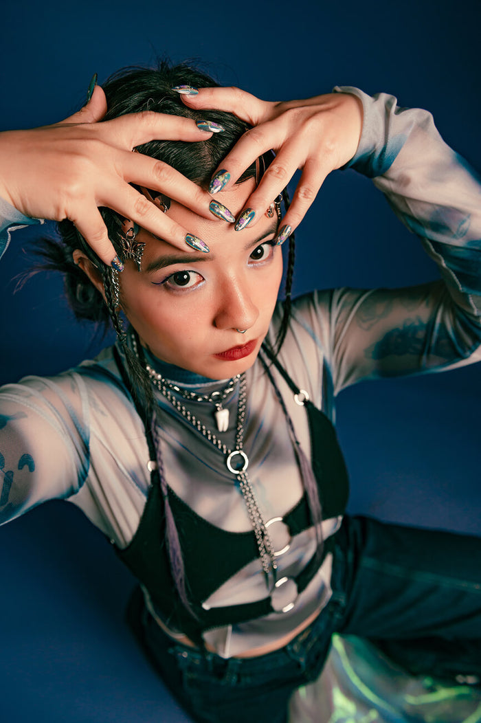 Woman with Cosmic Dance press-on nails, featuring alien mushroom butt design by Veronica Chen.