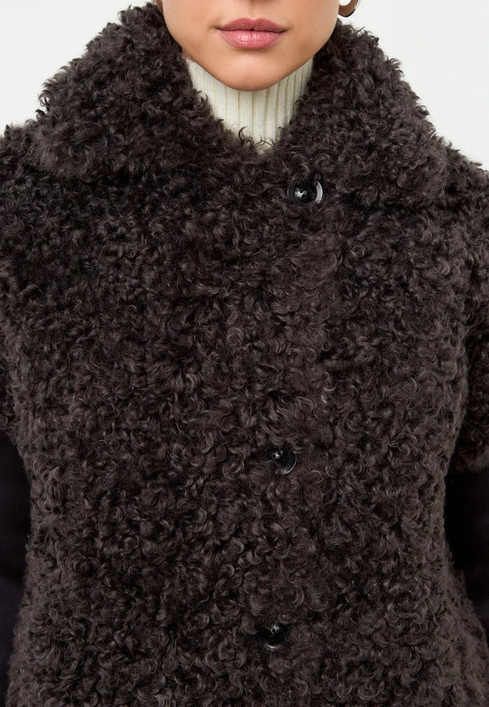 Stay warm and stylish with this cozy brown shearling Eva coat, a must-have black coat for the winter season.