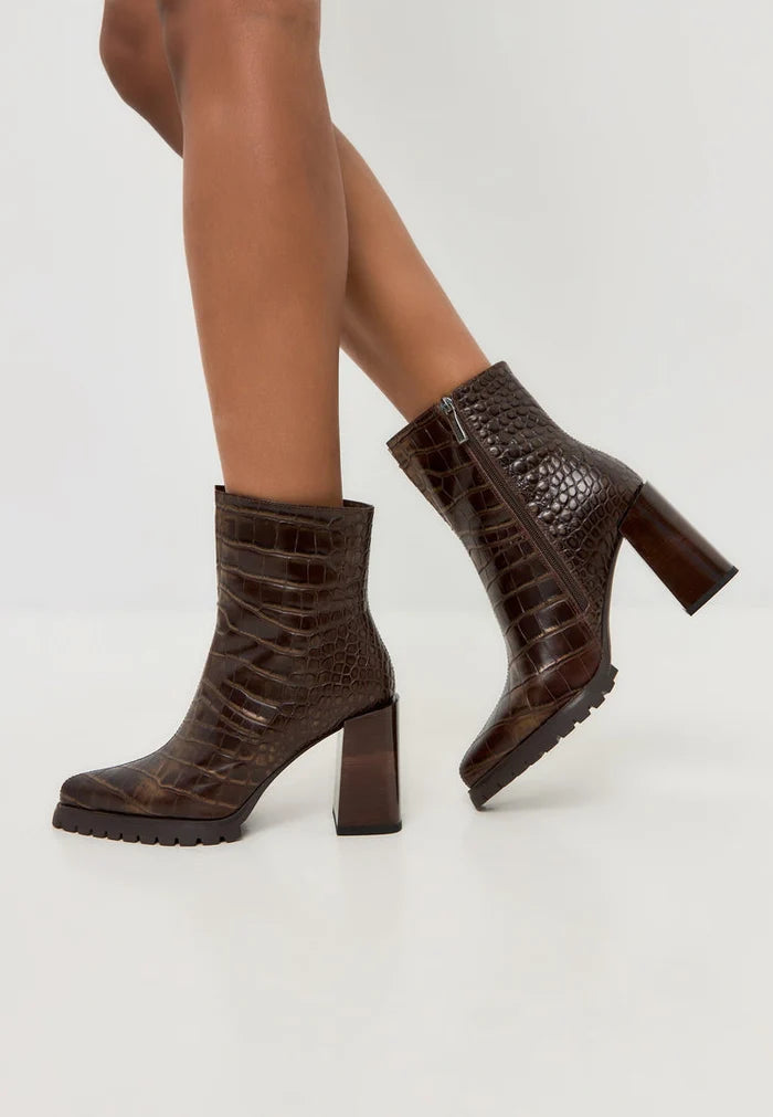 A stylish pair of women's croc block heel boots in brown, featuring a trendy crocodile texture design, known as the Helen boots.