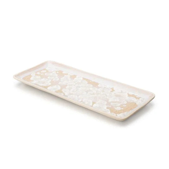 White and tan rectangular platter with crystalline texture and raised rim.