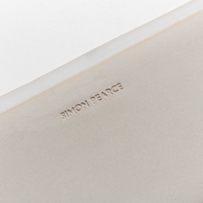 Small rectangular platter in cream ceramic with white rim and embossed "SIMONY PEARCE" text on surface.
