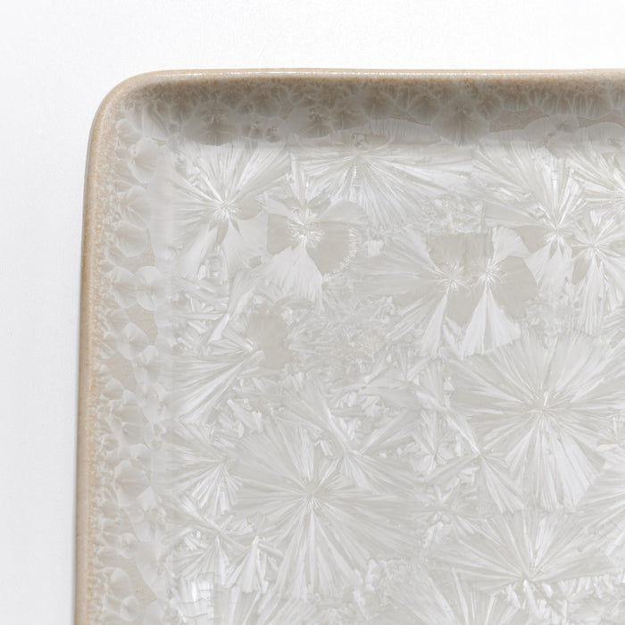 Clear crystalline rectangular platter with etched fan and geometric patterns throughout surface and decorative border.