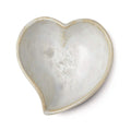 Heart-shaped bowl with crystalline white interior and tan-colored rim and exterior.