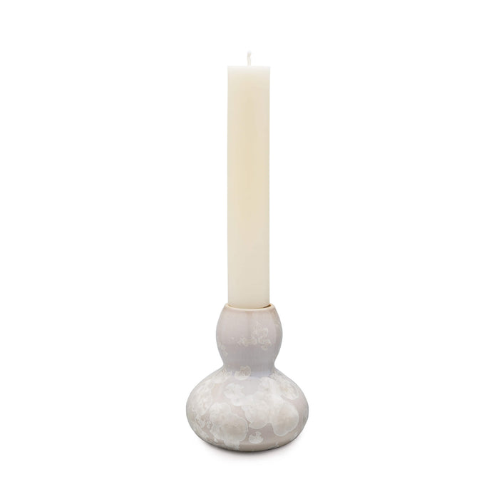 White crystalline candlestick holder with bulbous base and cylindrical socket holding a cream taper candle.
