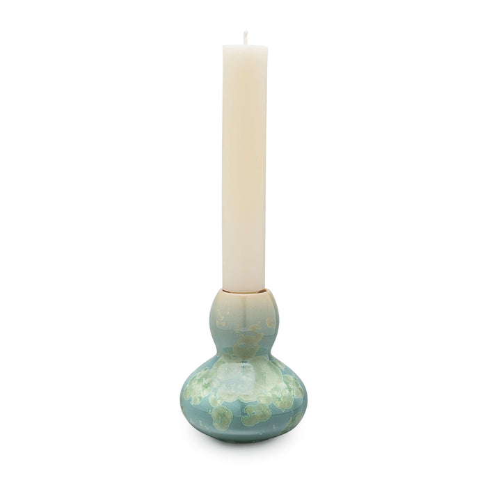 Jade-colored crystalline candlestick with bulbous base holding a cream pillar candle.