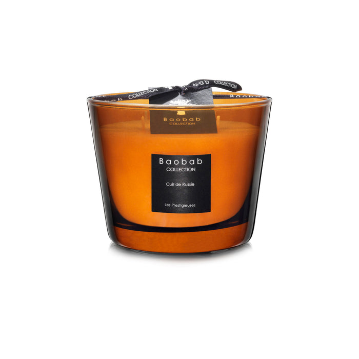 Baobab Collection Cuir de Russie candle in orange glass vessel with black label and ribbon bow.