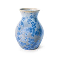 White ceramic vase with blue floral pattern and tapered neck.