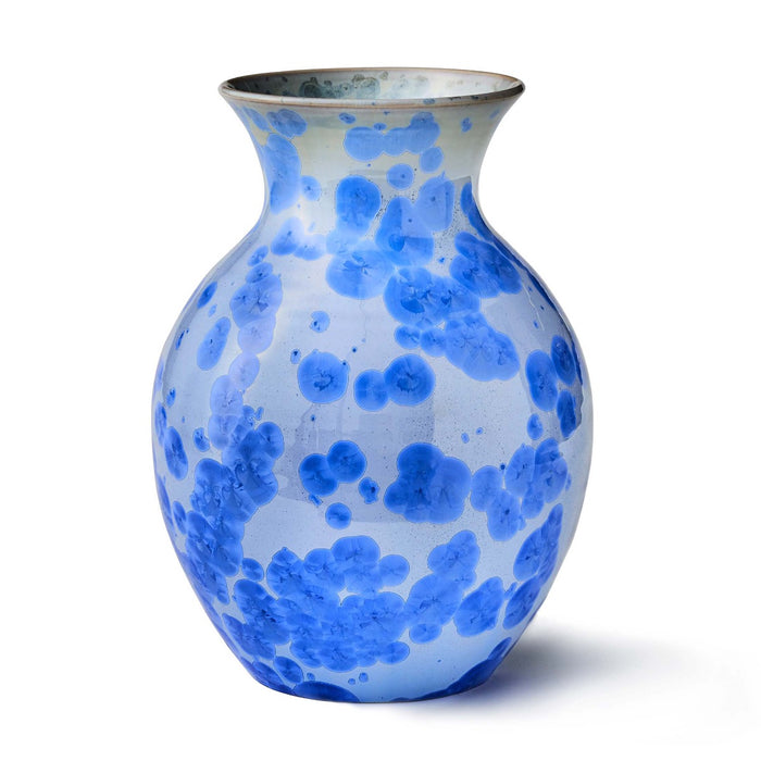 Blue and white ceramic vase with organic circular pattern and metallic rim.