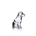 Clear glass dog figurine sitting upright with black detailing on head and body.