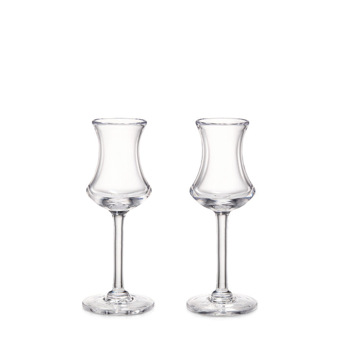 Two clear glass aperitif glasses with curved bowls and thin stems on circular bases.