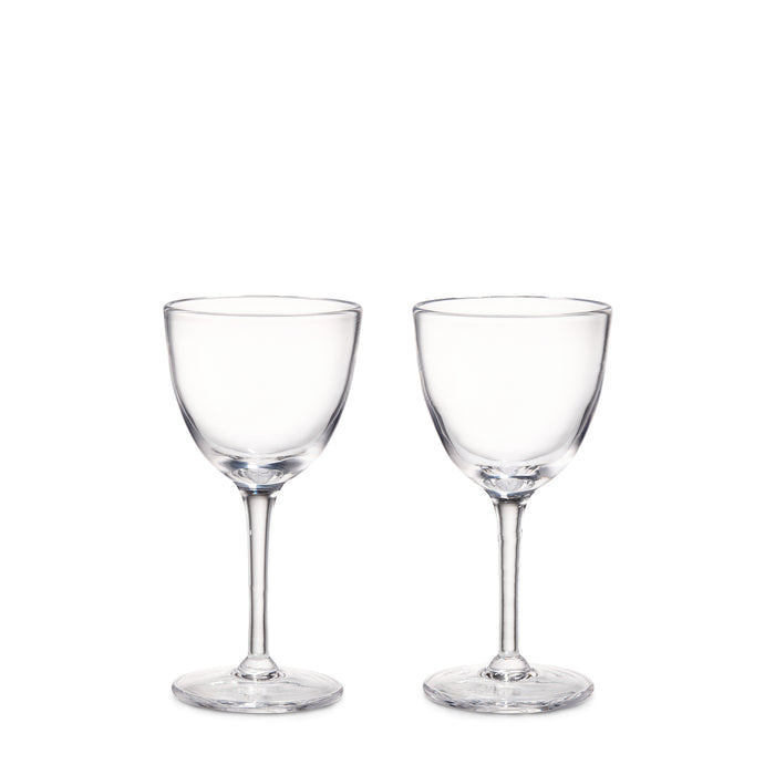Two clear glass cocktail glasses with rounded bowls and thin stems on circular bases.