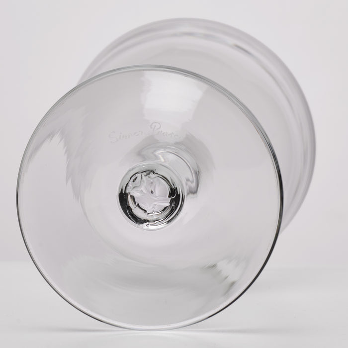 Two clear glass coupe glasses with wide bowls and etched branding, shown from above.