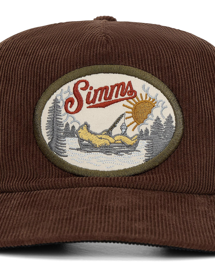 Brown cap with a embroidered patch featuring the Simms logo and outdoor scene.