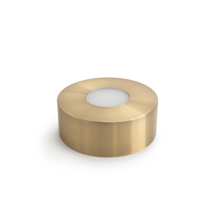 Brushed brass cylindrical LED base with white light diffuser panel on top.