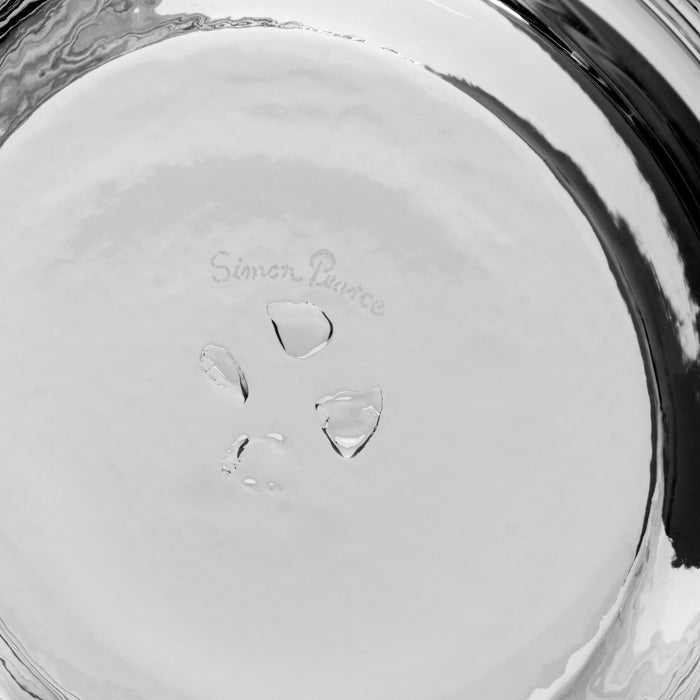 White ceramic coaster with "Simon Pearce" text and water droplets on surface.