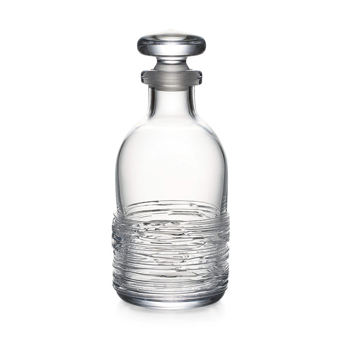 Clear glass decanter with textured lower body and matching stopper.