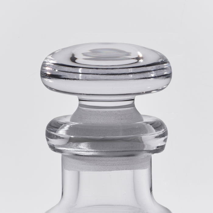 Clear glass decanter with wide mushroom-shaped stopper and horizontal stripe detailing.