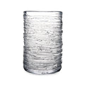 Clear glass tumbler with horizontal textured ridges throughout the cylindrical body.