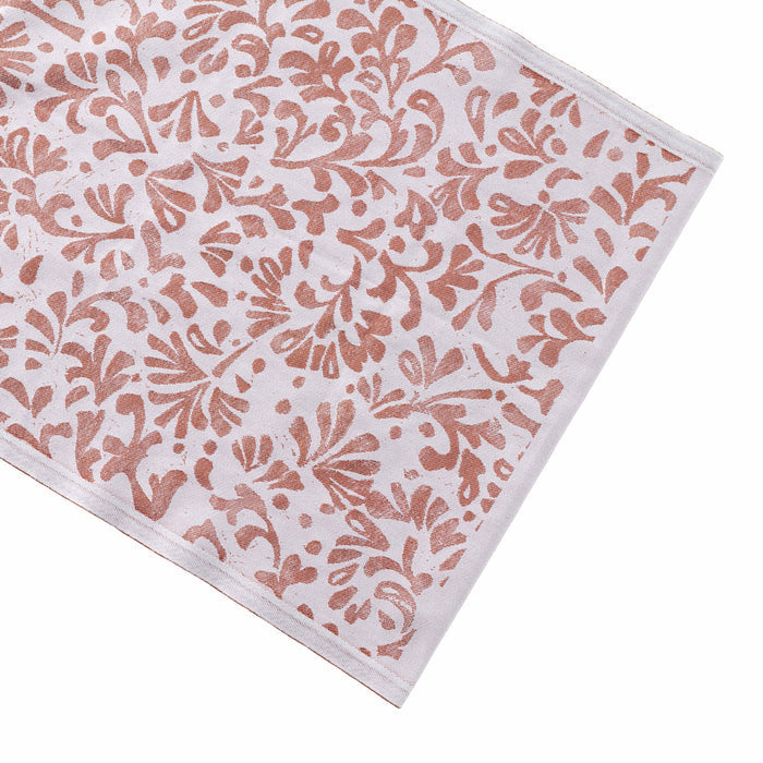 Cream and rust-colored runner with repeated floral leaf pattern throughout.