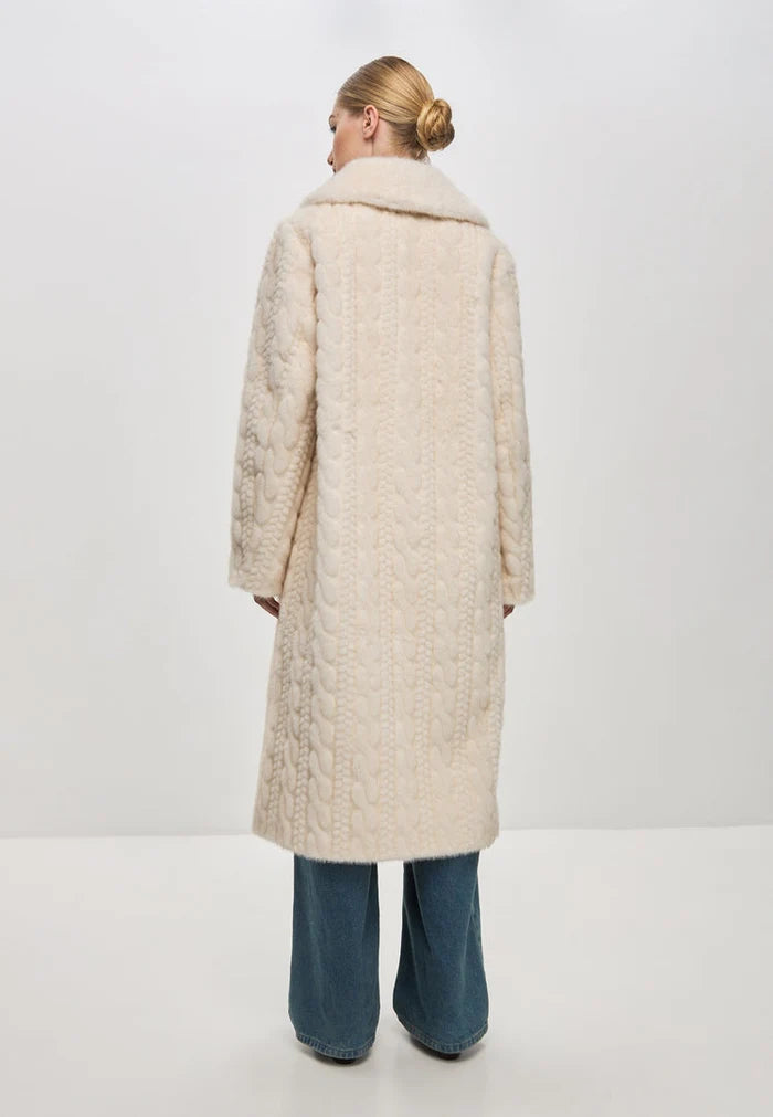 A stylish and elegant cream cable knit coat with faux fur detailing, perfect for staying warm and chic during the winter season.