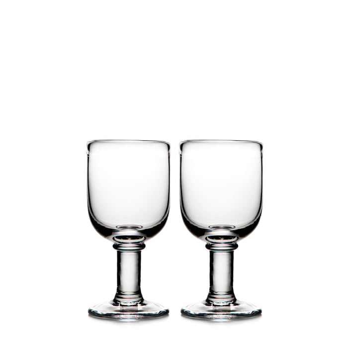 Two clear glass wine goblets with pedestal bases and rounded bowls.
