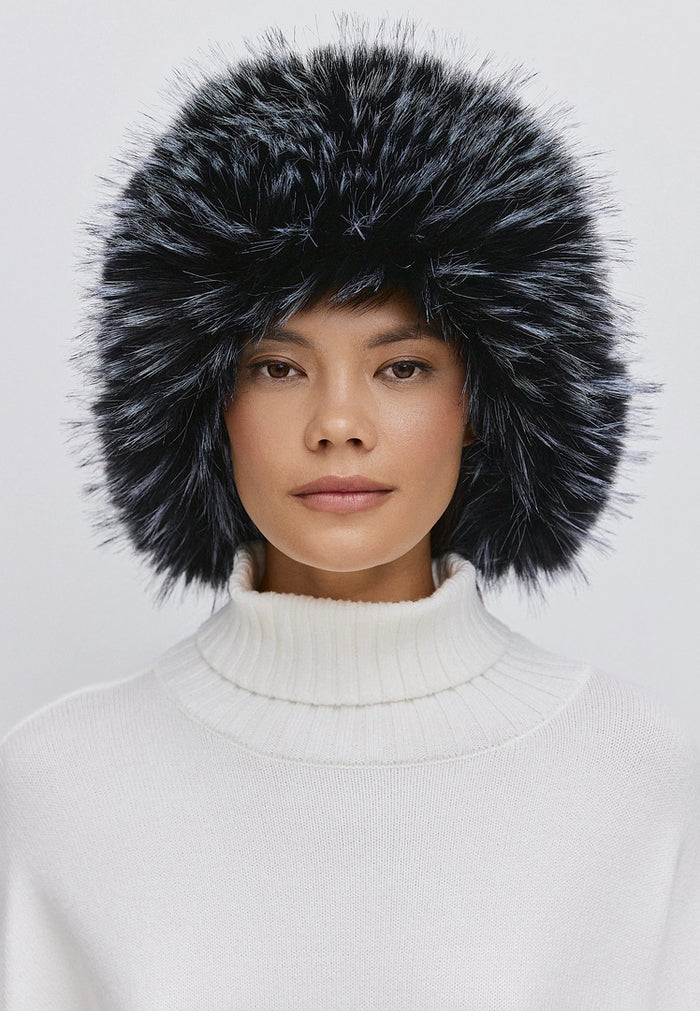 Woman wearing a stylish blue faux fur hat, perfect for winter fashion and warmth.