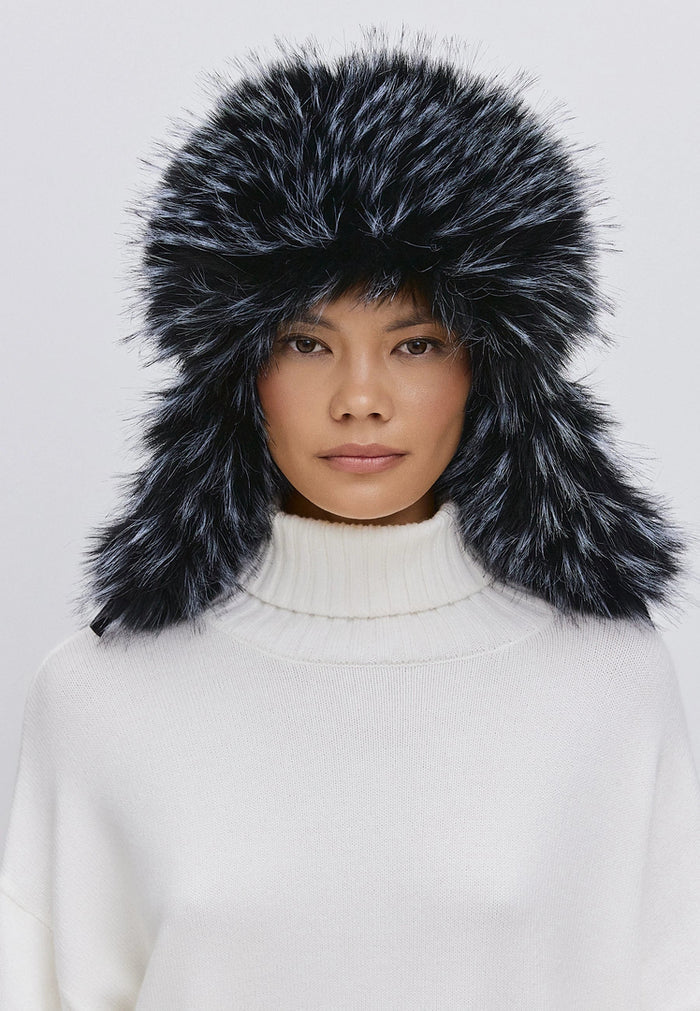 Woman wearing a stylish blue faux fur hat, perfect for winter fashion.