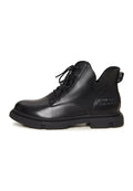 A pair of stylish black leather women's flat sole ankle boots with a chic design, perfect for everyday wear.