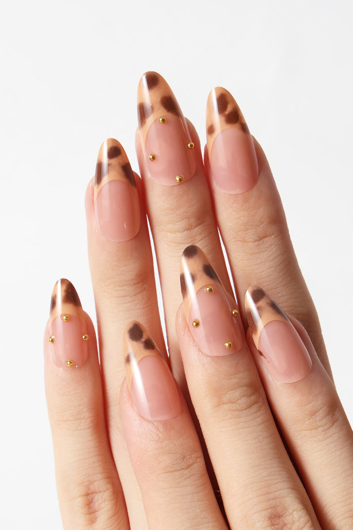 French tip press on nails with leopard print and gold stud accents