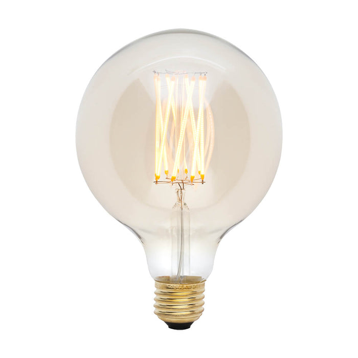 Clear globe LED bulb with warm-toned glowing filaments and brass base.