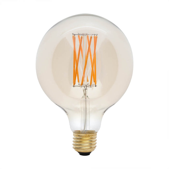 Round clear LED bulb with orange filament strands and brass base.