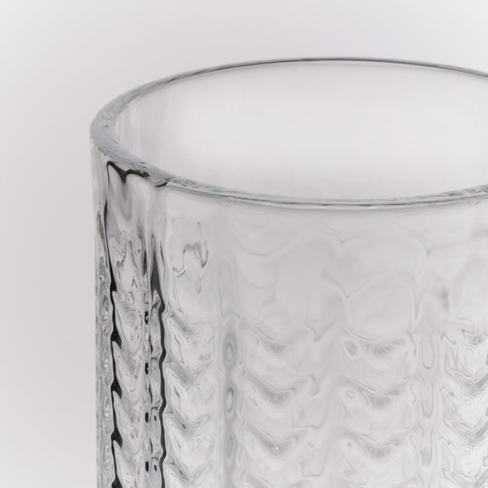 Clear glass Collins glass with geometric textured pattern and smooth rim.