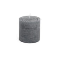 Grey cylindrical pillar candle with white wick, textured finish surface.