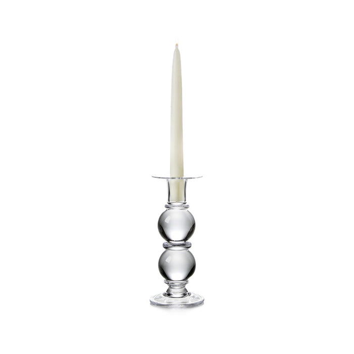 Clear glass candlestick with stacked spherical base holding a cream-colored taper candle.