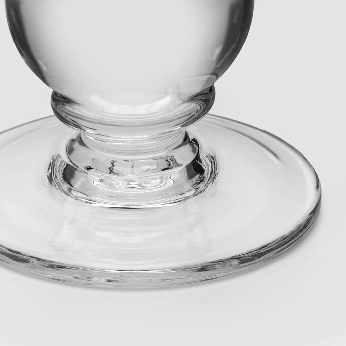 Clear glass candlestick with ribbed stem detail and wide circular base.