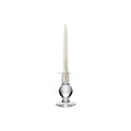 Clear glass candlestick with spherical base holding a tall tapered cream candle.